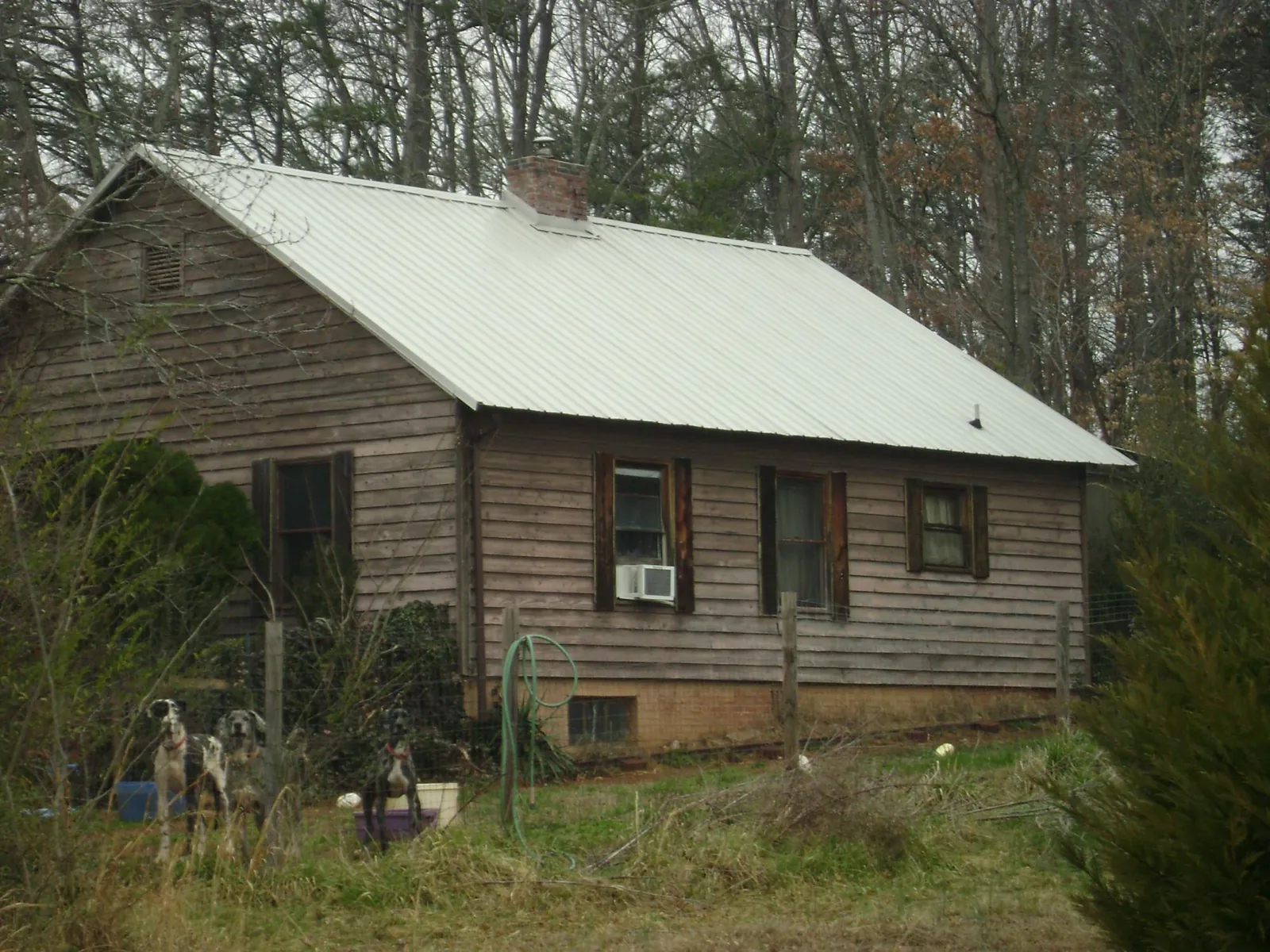 White metal roof on an old wood sided farmhouse, from a Metal Roof Installation job in Colliers